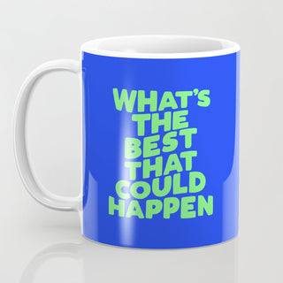 Blue and white ceramic mug with green text that says “What's the Best That Could Happen” front view. 